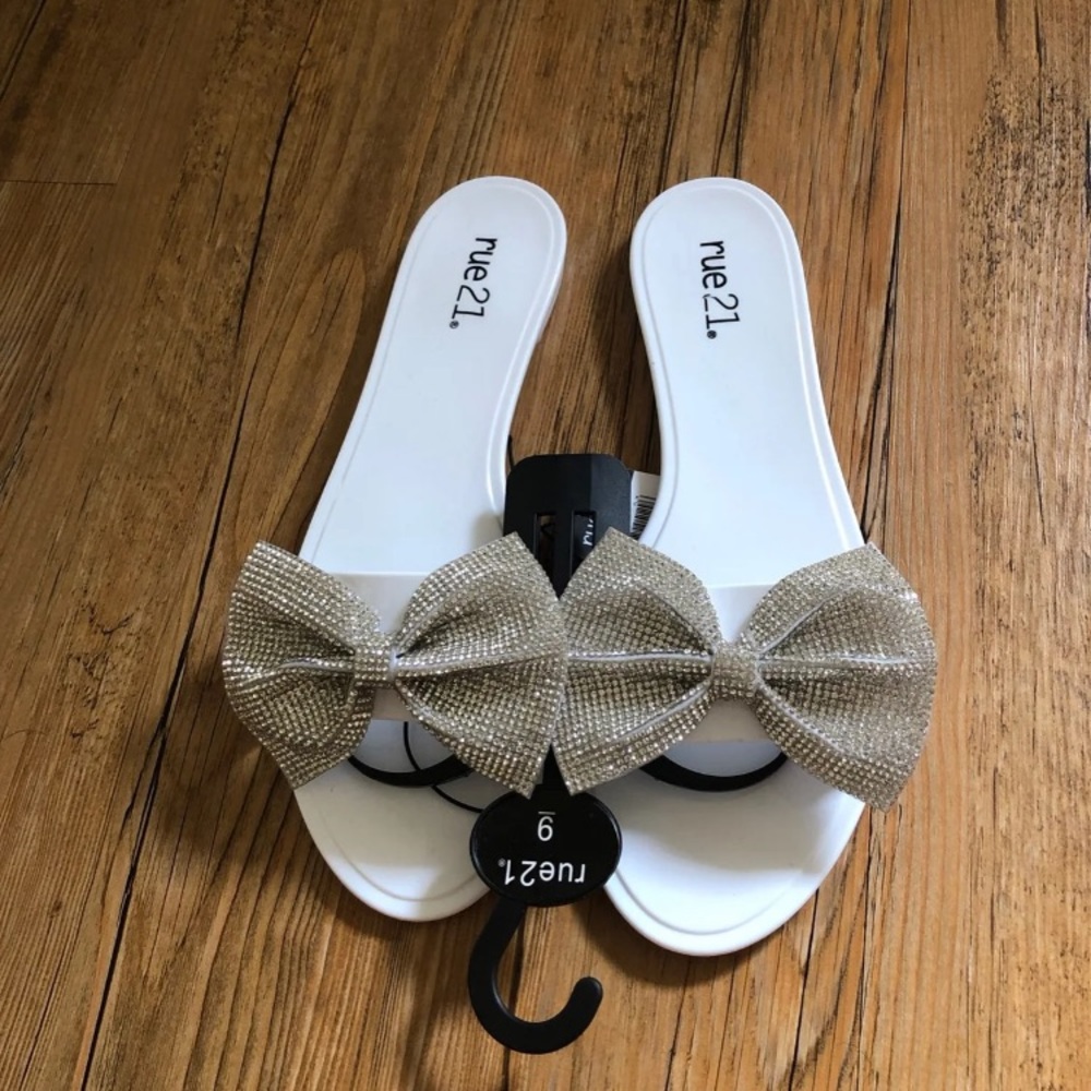 White bow sandals with faux rhinestone details.